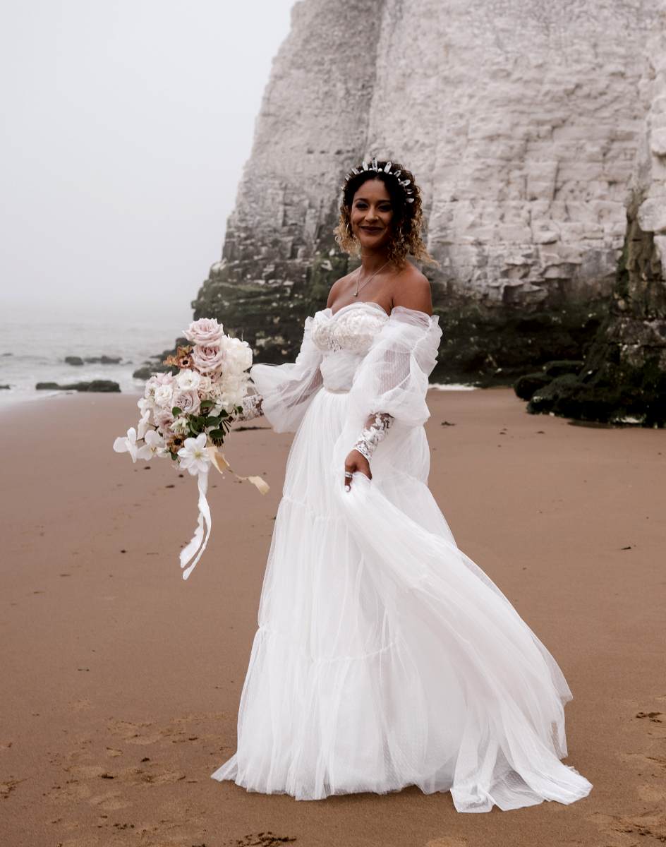 bride on a beach with a bouquet